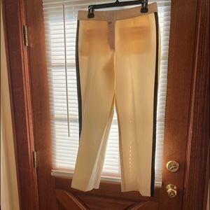 Off white cropt pants with black stript on the sid